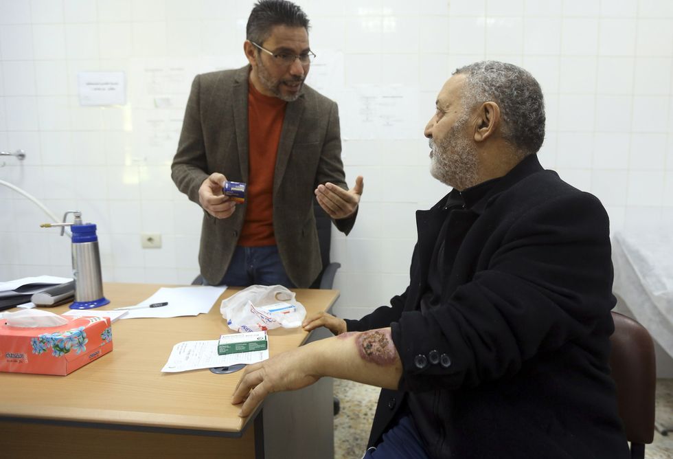 A doctor speaks to a patient suffering from Leishmaniasis