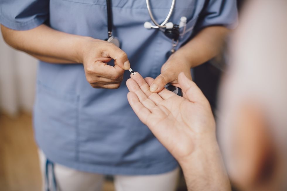 A doctor taking a blood sample