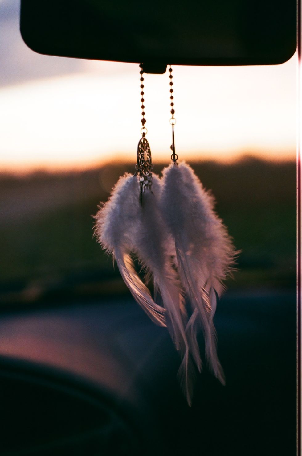 A dream catcher on a rear-view mirror