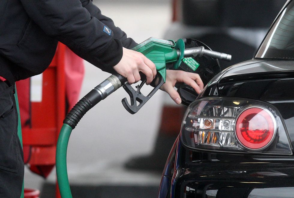 A driver filling their car up with fuel