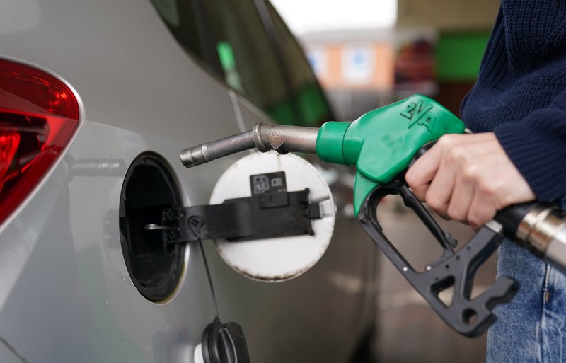 A driver holding a petrol pump.