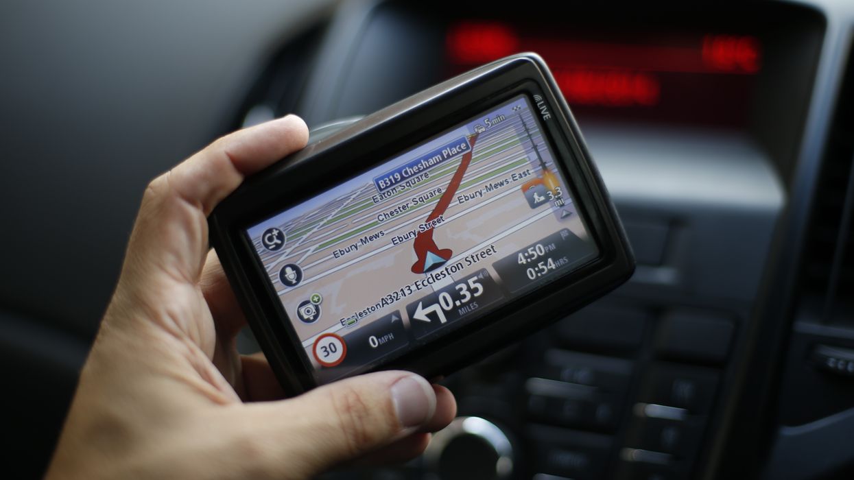 A driver holding a sat nav