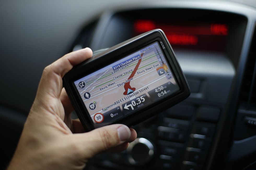 A driver holding a sat nav