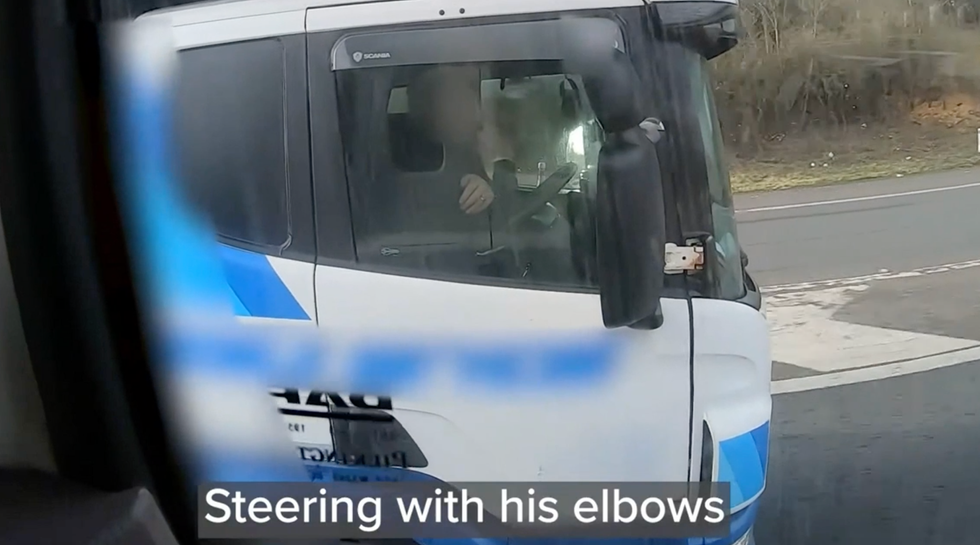 A driver is caught steering his lorry with his elbow.