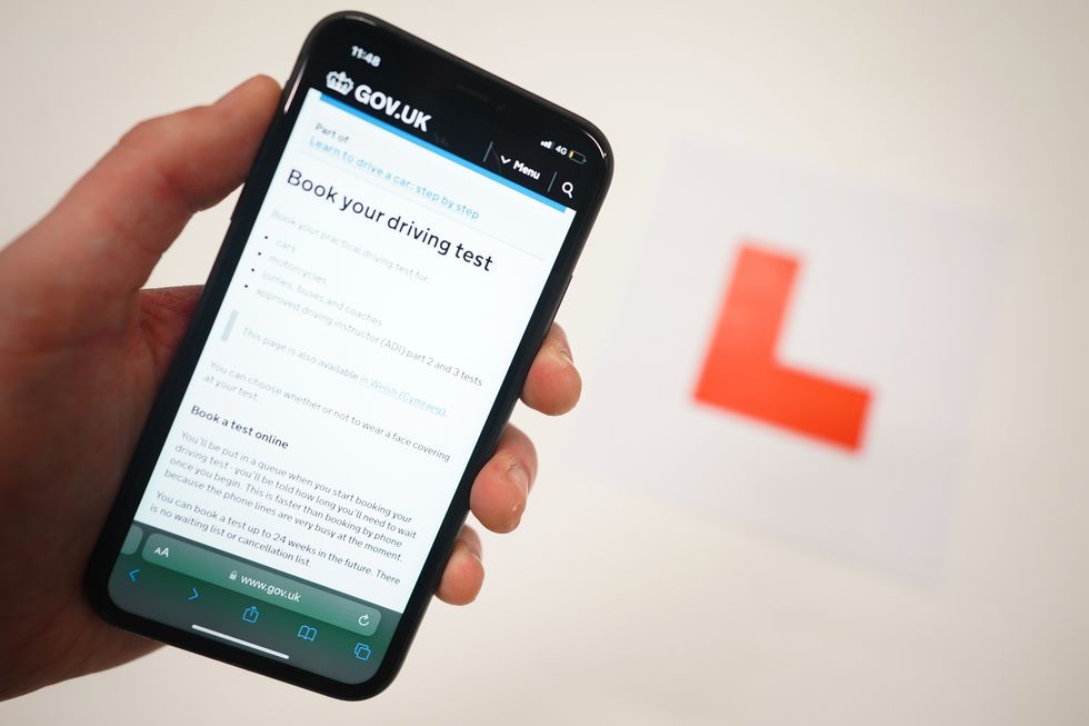 A driving test booking screen and a learner plate