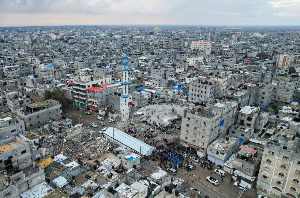 A drone view shows Palestinians holding Eid al-Fitr prayers by the ruins of al-Farouk mosque