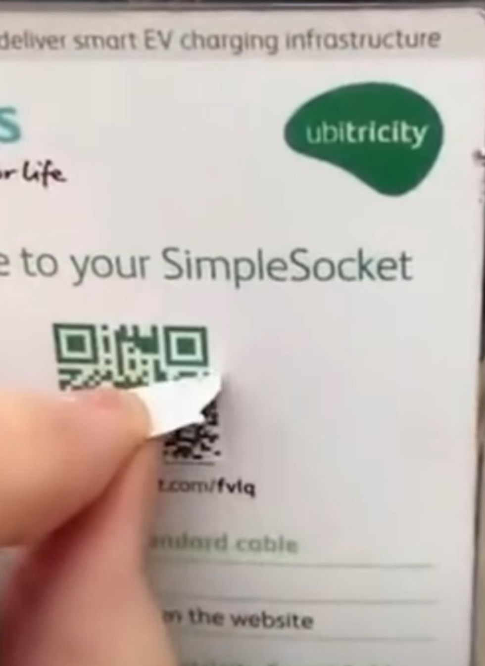 A fake sticker on top of a green QR code showing people how to use the EV charger