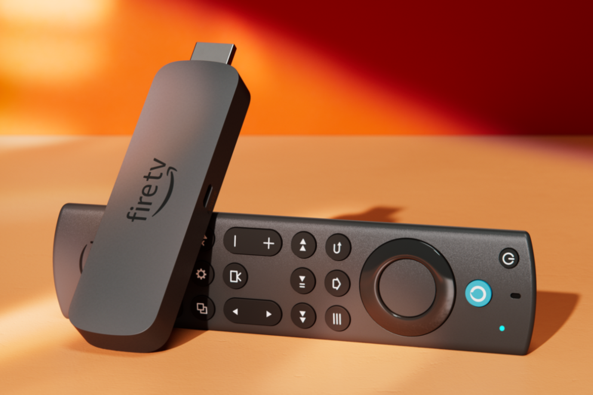 a fire tv stick pictured lying on its side in warm sunlight