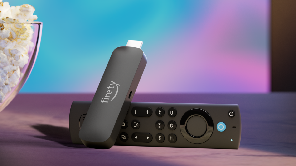 a fire tv stick sits next to a bowl of popcorn