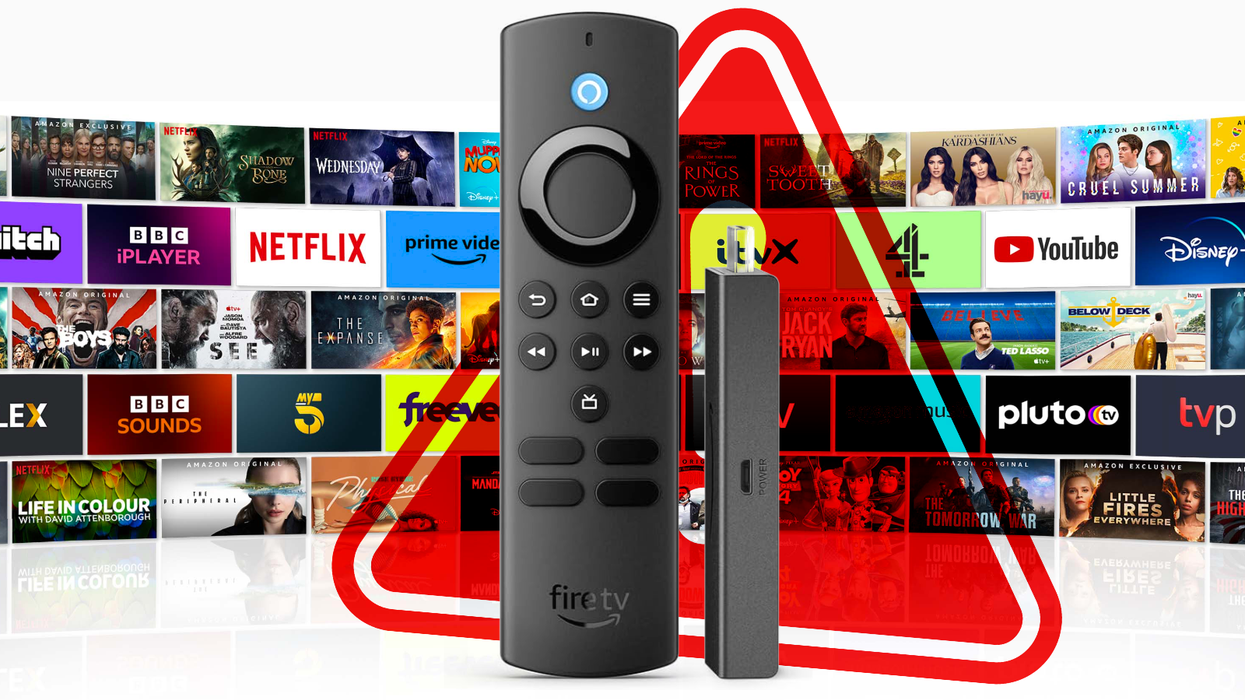 a fire tv stick stands with a selection of shows behind it