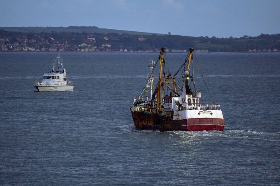 A fishing trawler leaves the harbour in Portsmouth.