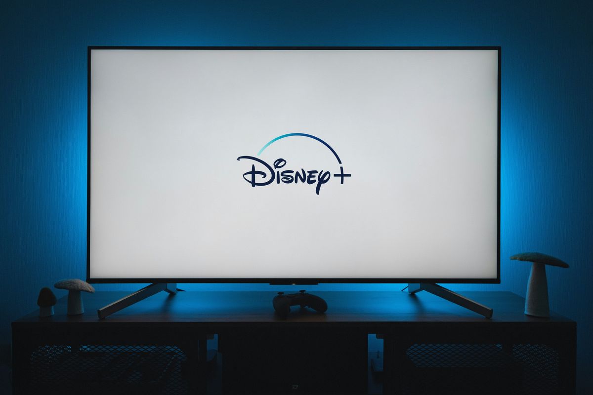 a flatscreen tv with the disney plus logo displayed on-screen 