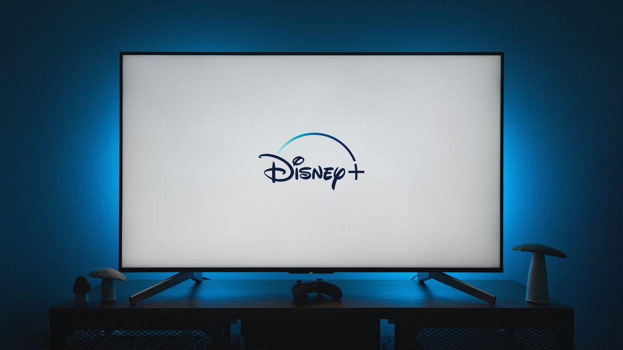 a flatscreen tv with the disney plus logo displayed on-screen