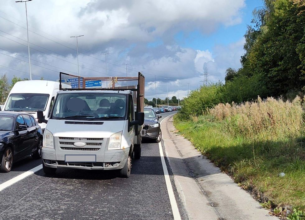 A Ford Transit van on the hard shoulder of the motorway