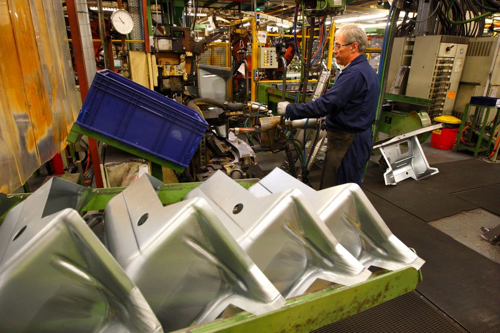 A Ford worker welds wheel arches for Transit vans at their factory in Southampton, Hampshire where 125 vans roll off the production line each day.