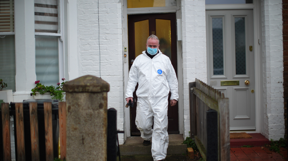 A forensic officer at the scene of the murder