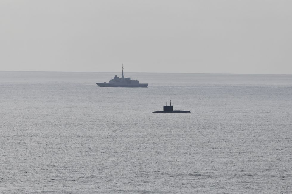 A French Navy frigate conducts surveillance of the Alliance\u2019s maritime approaches, marking the presence of a Russian submarine operating on the surface off the coast of Brittany
