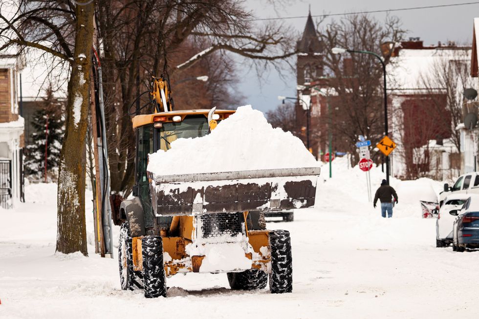 A front loader removes snow from street following a winter storm in Buffalo, New York, U.S., December 27, 2022. REUTERS/Lindsay DeDario