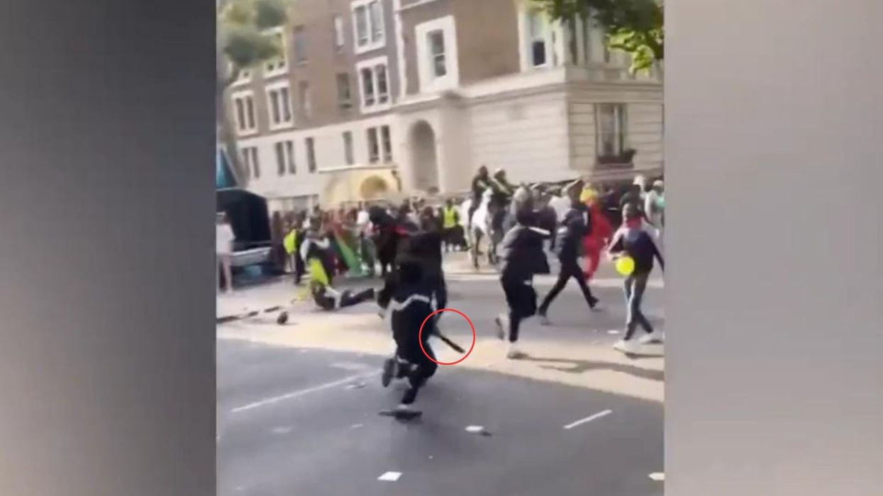 A gang of youths were spotted running away from the scene at Notting Hill Carnival with one holding a suspected machete after eight people were stabbed