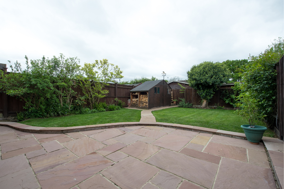 A garden patio with a lawn