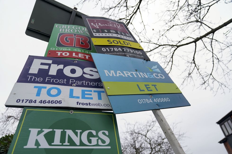 A general view of estate agent boards outside a property in Staines-upon-Thames in Surrey. Picture date: Monday January 10, 2022.