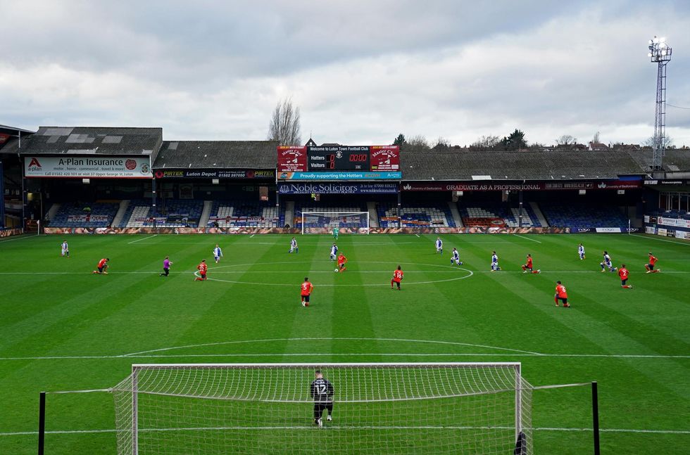 A general view of players taking a knee in solidarity of the Black Lives Matter movement before the Sky Bet Championship match at Kenilworth Road, Luton.