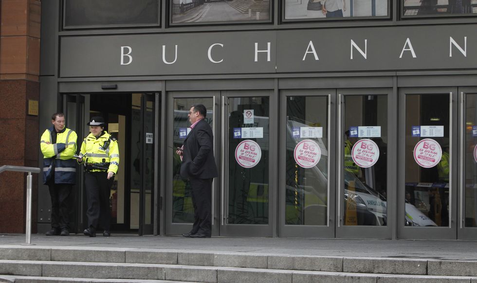 A general view of the police and security staff outside the Buchanan Galleries in Glasgow city centre where part of the busy shopping centre was closed after a man %22fell from a height%22 inside.