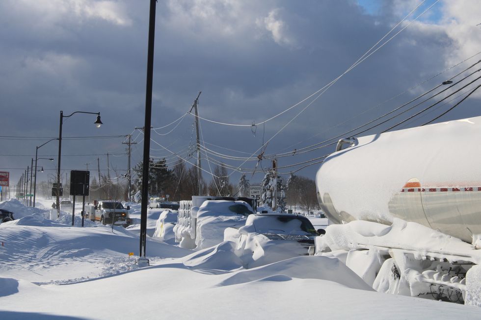 A general view of vehicles covered in snow on a road, following a winter storm that hit the region, in Buffalo, New York, U.S December 25, 2022, in this picture obtained by Reuters from social media on December 26, 2022. Instagram/Jason Murawski Jr/via REUTERS THIS IMAGE HAS BEEN SUPPLIED BY A THIRD PARTY. MANDATORY CREDIT. NO RESALES. NO ARCHIVES.