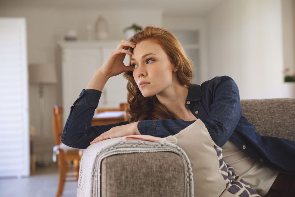 A Generic Photo of thoughtful woman sitting on the sofa. See PA Feature LIFE Lockdown. Picture credit should read: Alamy/PA. WARNING: This picture must only be used to accompany PA Feature LIFE Lockdown.