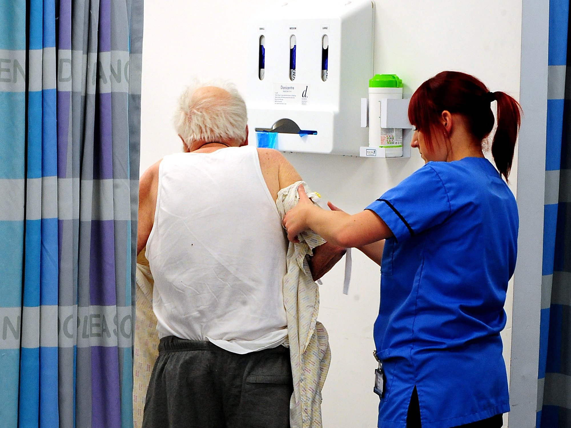 A generic stock photo of a nurse helping an elderly patient at Queen Elizabeth Hospital, Birmingham