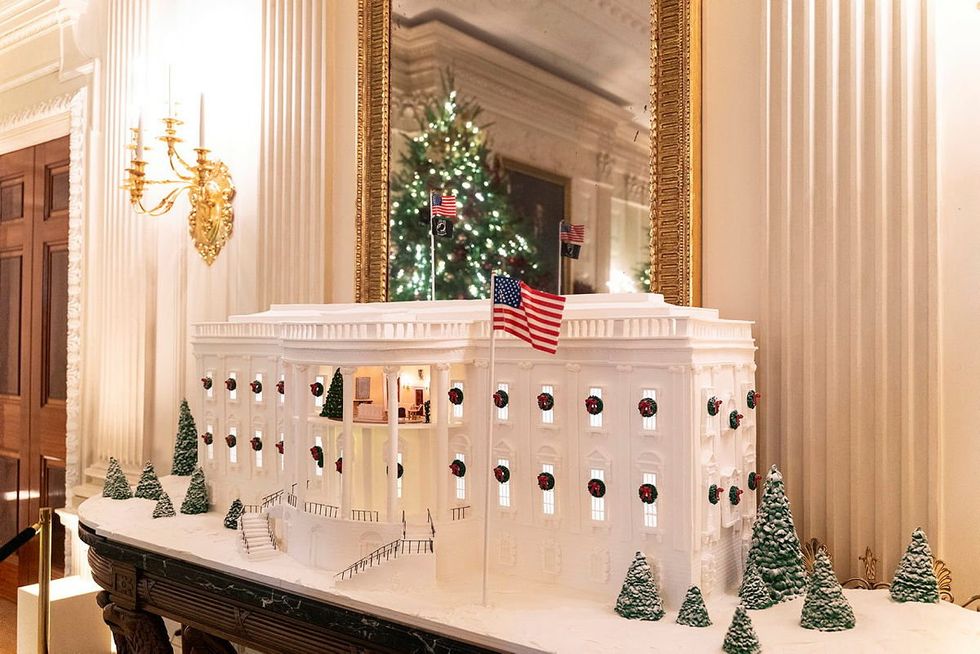 A gingerbread White House has been positioned in the State Dining Room