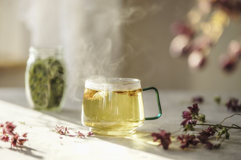 A glass cup of steaming herbal tea