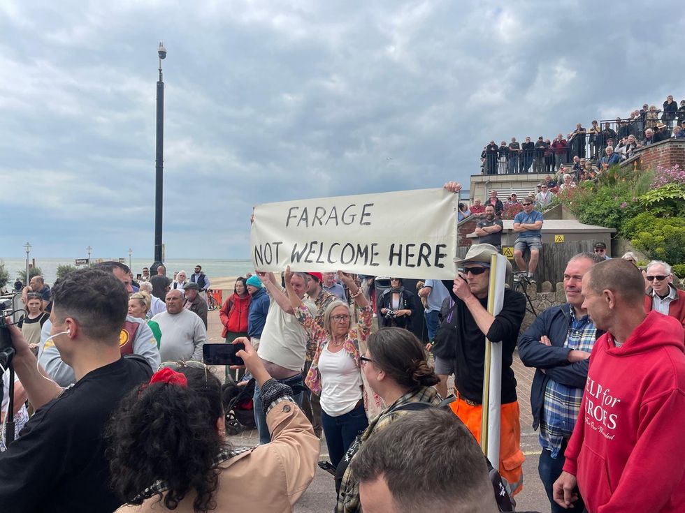 A group of anti-Farage protesters holding a banner