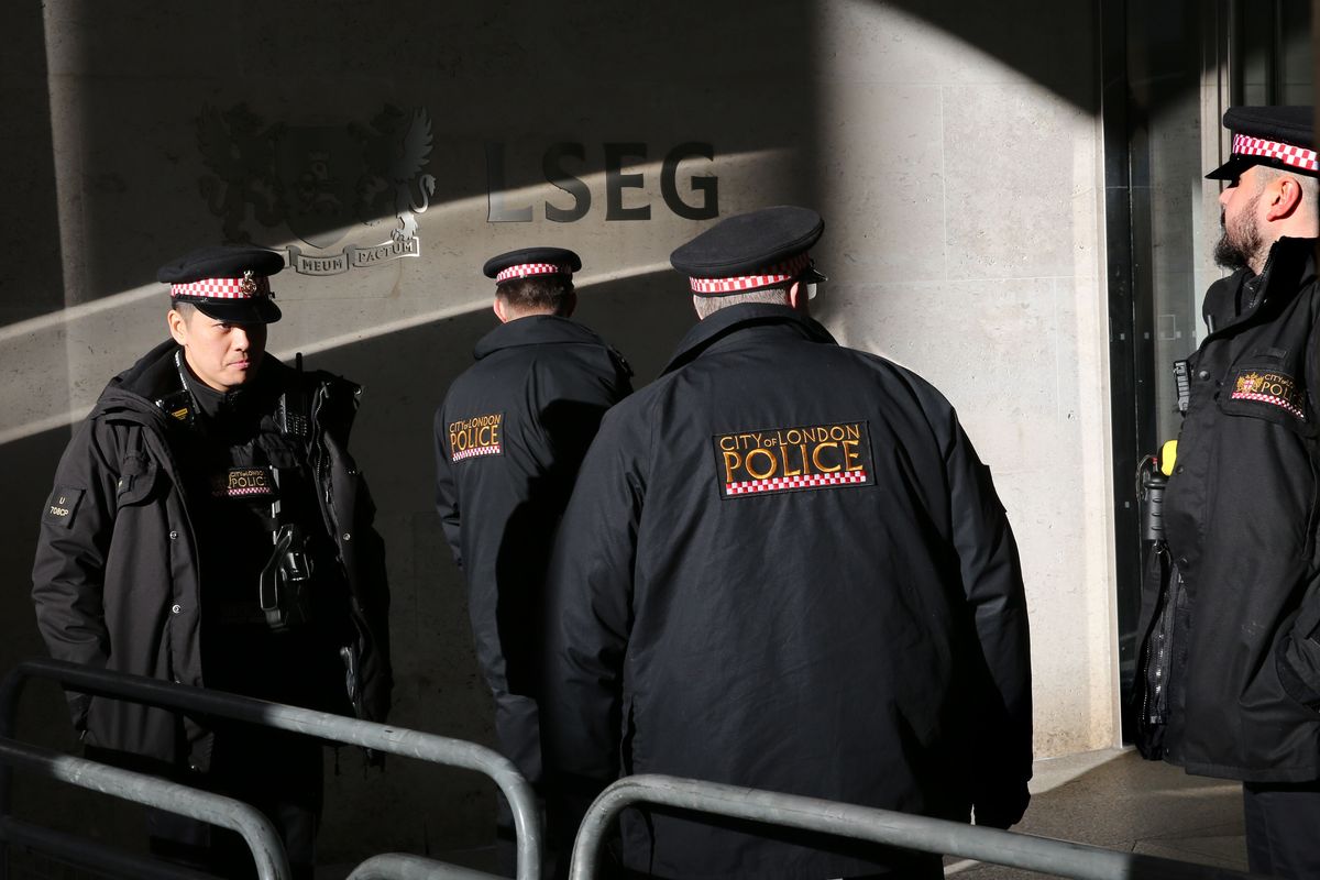 a group of city of london police pictured in their uniform outside