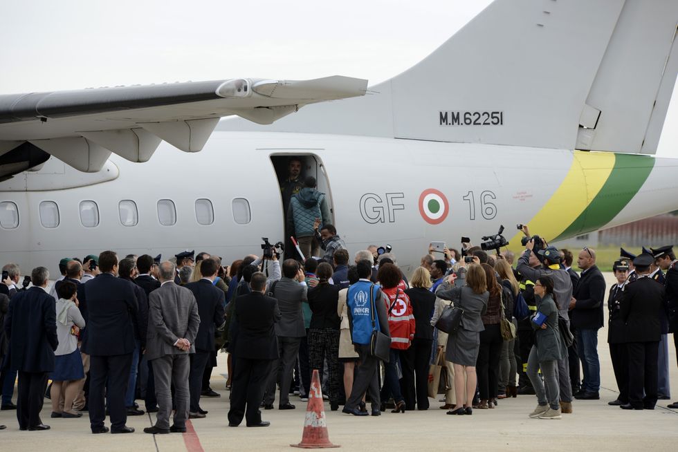 A group of migrants boarding a plane ready to fly to Sweden from Italy in 2015\u200b