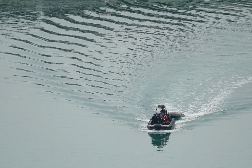 A group of people thought to be migrants are brought in to Dover, Kent, by Border Force officers, following a small boat incident in the Channel. Picture date: Thursday December 16, 2021.