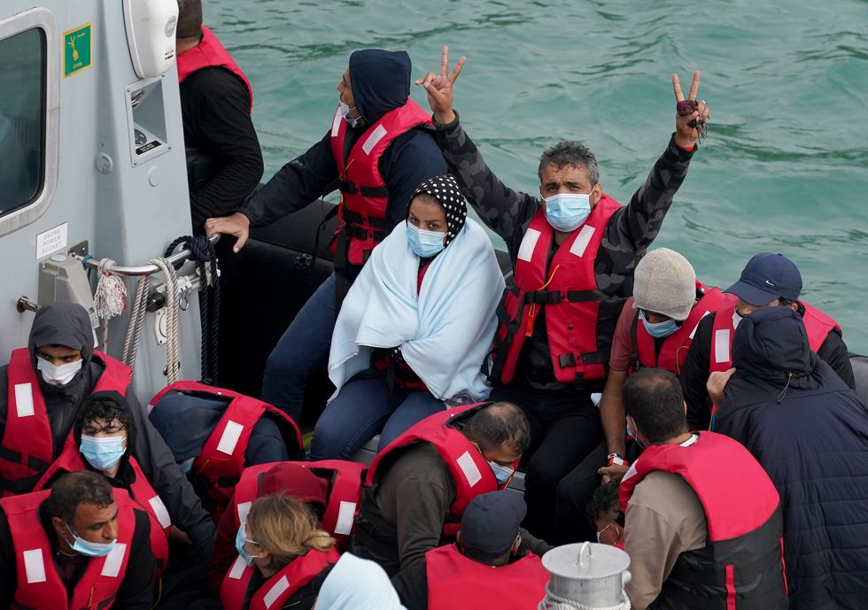 A group of people thought to be migrants are brought in to Dover, Kent, by Border Force officers, following a small boat incident in the Channel.