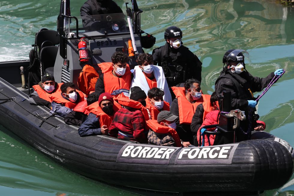 A group of people thought to be migrants are brought in to Dover, Kent, following a small boat incident in the Channel earlier this morning. Picture date: Monday June 7, 2021.