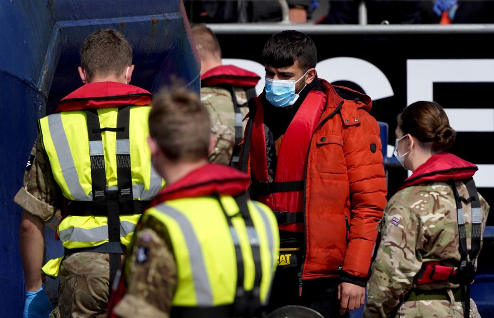 A group of people thought to be migrants are brought in to Dover, Kent, following a small boat incident in the Channel. Picture date: Tuesday April 19, 2022.