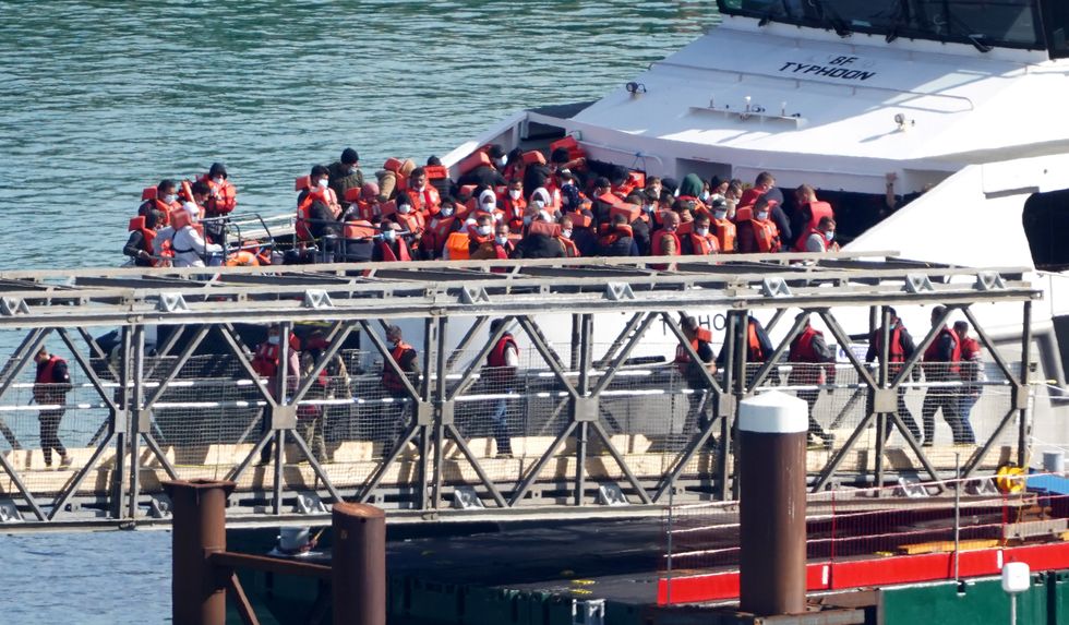 A group of people thought to be migrants, are brought in to Dover, Kent, from a Border Force vessel following a small boat incident in the Channel. Picture date: Monday September 12, 2022.