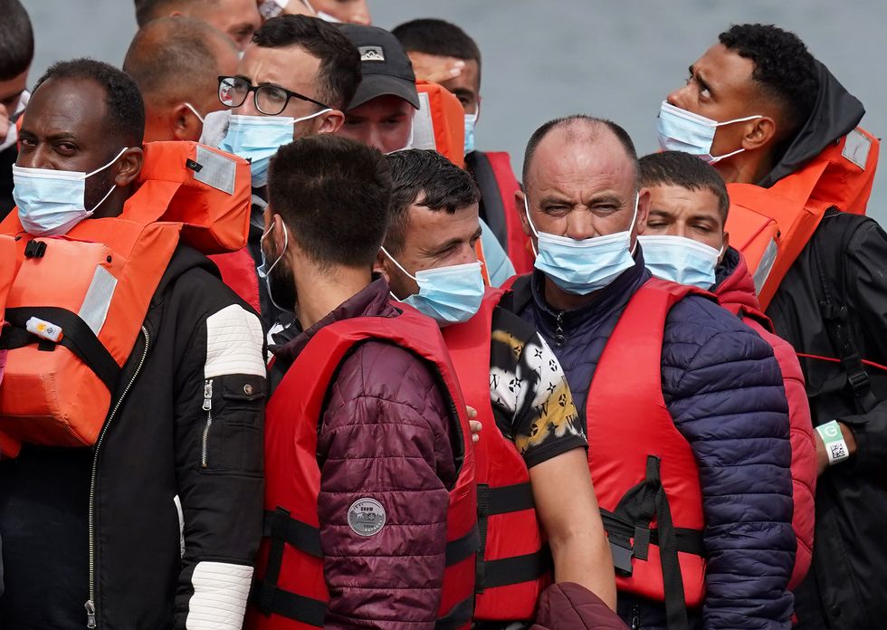 A group of people thought to be migrants are brought in to Dover, Kent, from a Border Force Vessel, following a small boat incident in the Channel. Picture date: Tuesday August 23, 2022.