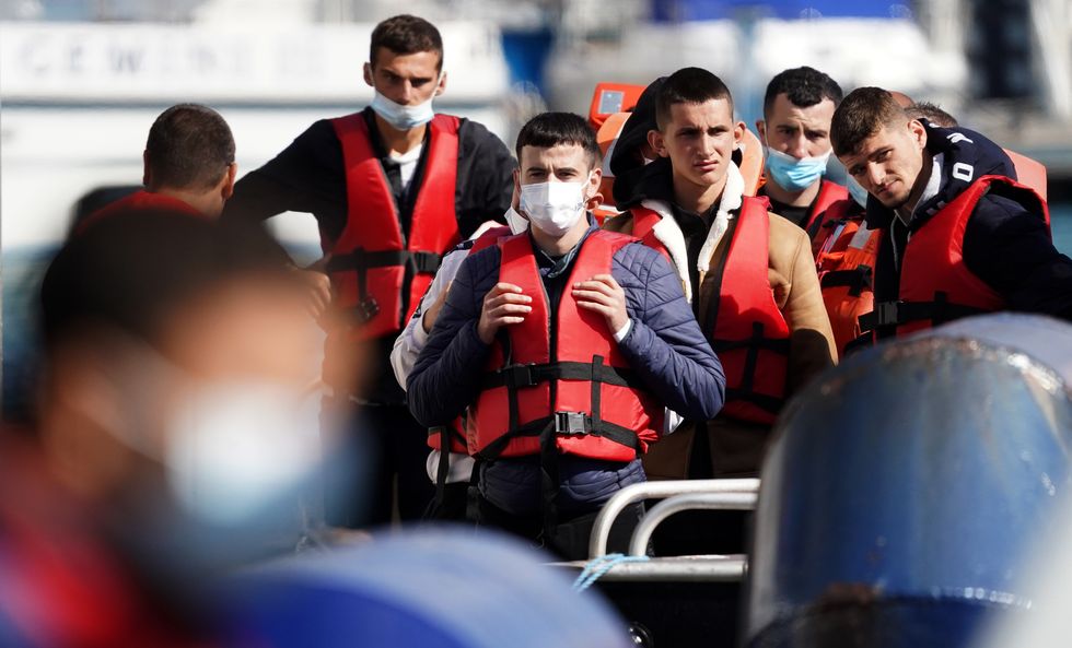 A group of people thought to be migrants are brought in to Dover, Kent, from a Border Force Vessel, following a small boat incident in the Channel. Picture date: Tuesday August 23, 2022.