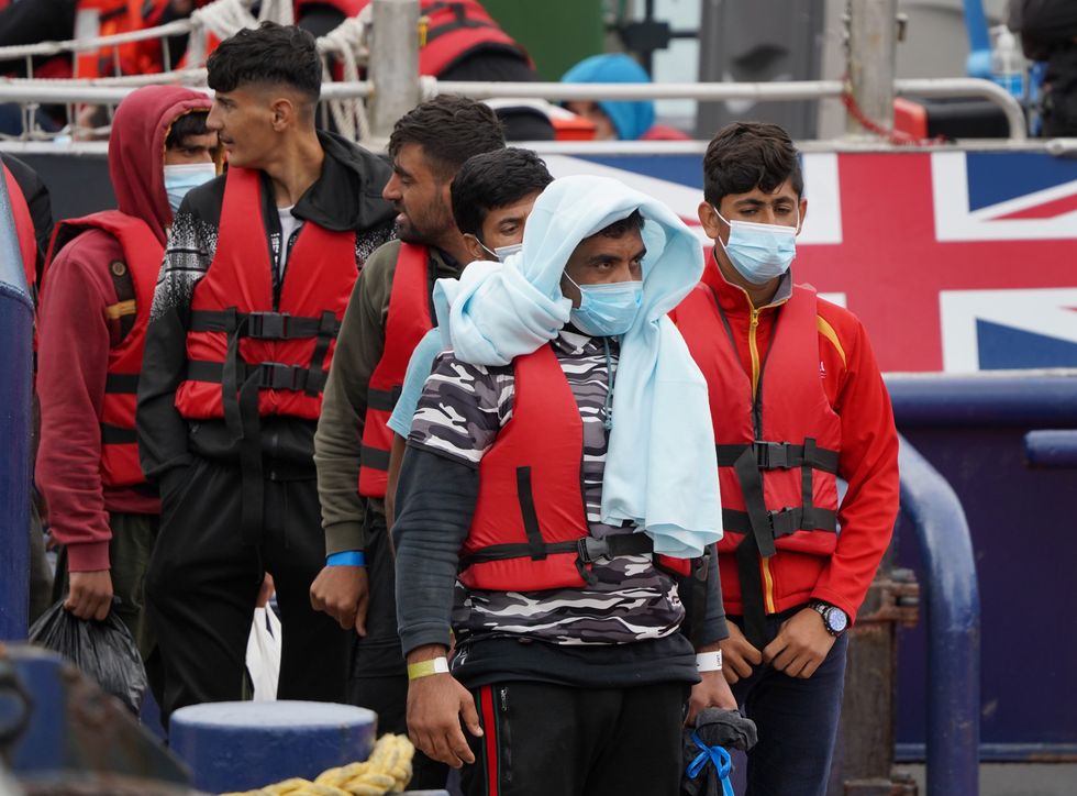 A group of people thought to be migrants are brought in to Dover, Kent, from a Border Force vessel, following a small boat incident in the Channel. Picture date: Monday August 22, 2022.