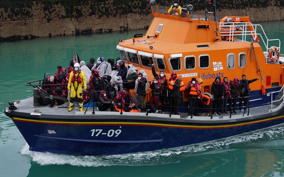 A group of people thought to be migrants are brought in to Dover, Kent, on board the Dover lifeboat.