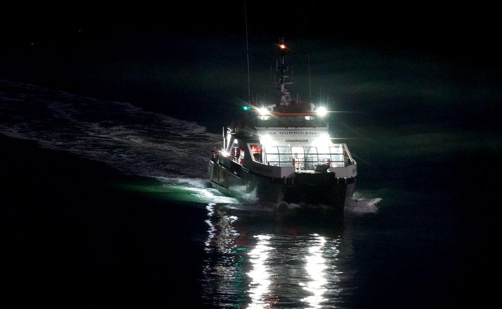 A group of people thought to be migrants are brought in to Dover, Kent, onboard a Border Force vessel at night