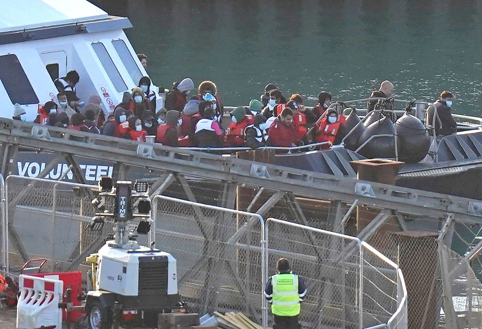 A group of people thought to be migrants are brought in to Dover, Kent, onboard a Border Force vessel following a small boat incident in the Channel. Picture date: Sunday October 9, 2022.