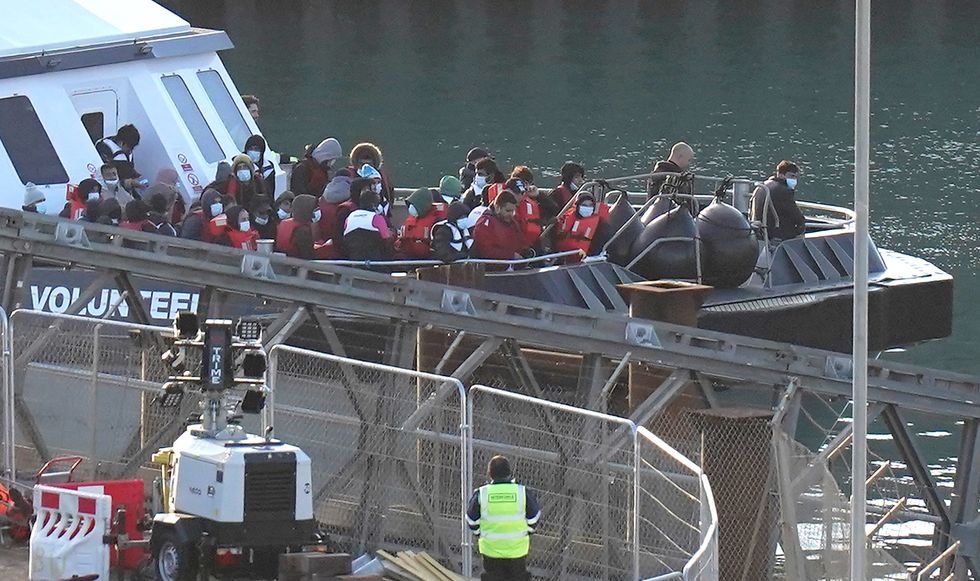 A group of people thought to be migrants are brought in to Dover, Kent, onboard a Border Force vessel following a small boat incident in the Channel. Picture date: Sunday October 9, 2022.