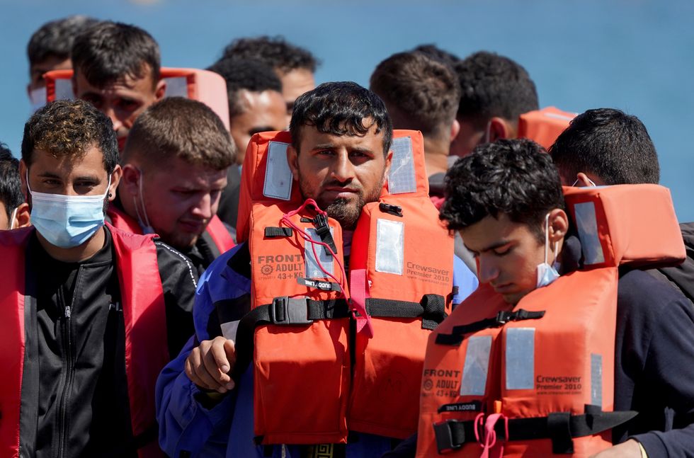 A group of people thought to be migrants are brought in to Dover, Kent, onboard a Border Force vessel following a small boat incident in the Channel. Picture date: Monday July 11, 2022.