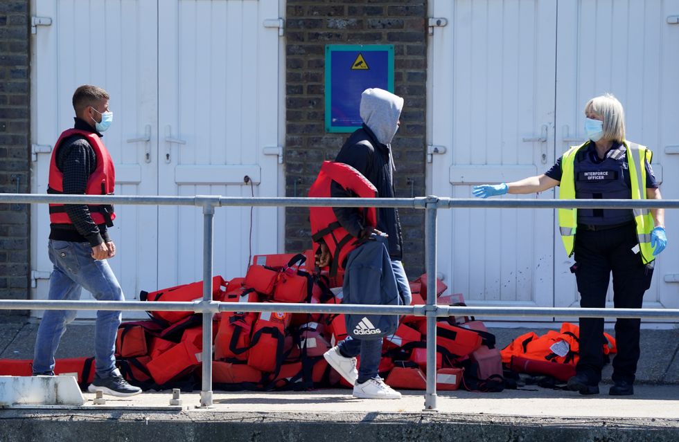 A group of people thought to be migrants are brought in to Dover, Kent, onboard a Border Force vessel following a small boat incident in the Channel. Picture date: Monday July 11, 2022.