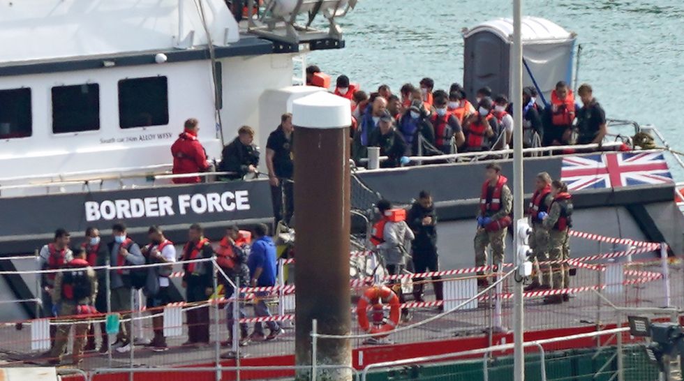 A group of people thought to be migrants are brought in to Dover, Kent